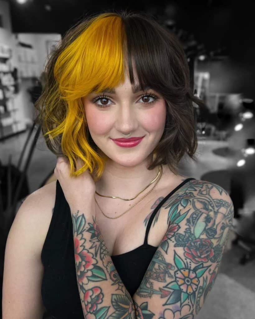 short bob with fringe and mustard peekaboo 