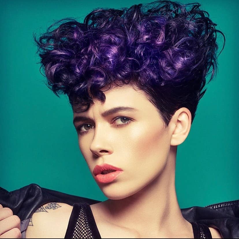 stacked purple curly pixie cut