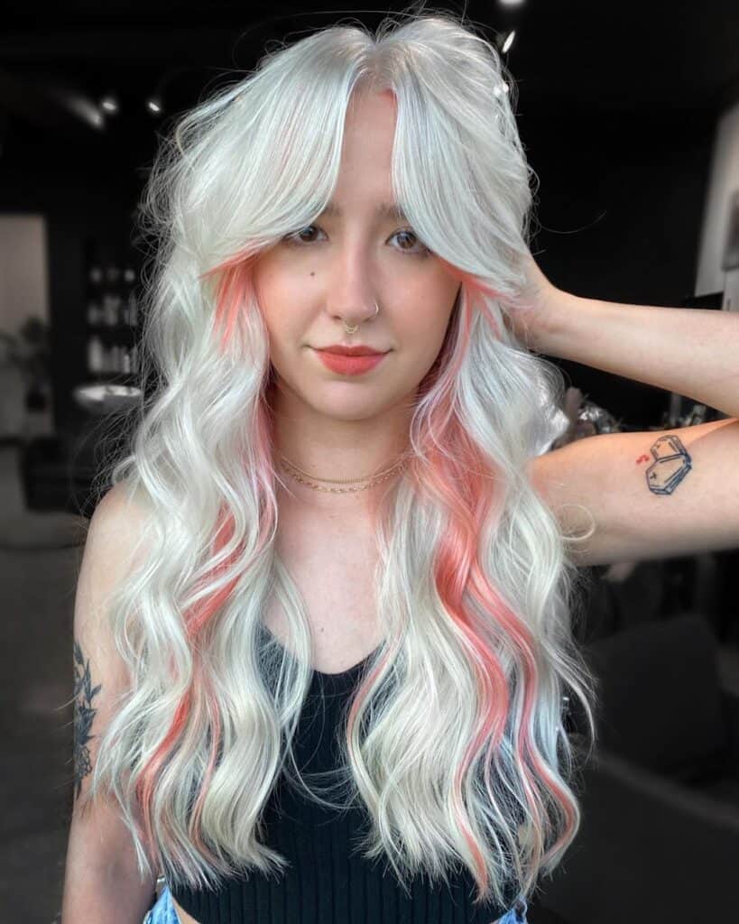 Feathered curtain bangs on platinum blonde hair 