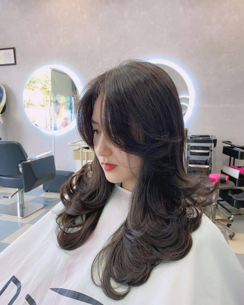 curtain bangs on a layered  cut