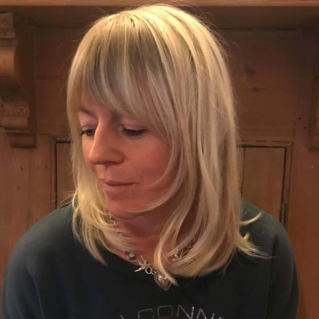 choppy face framing layers on short blonde hair