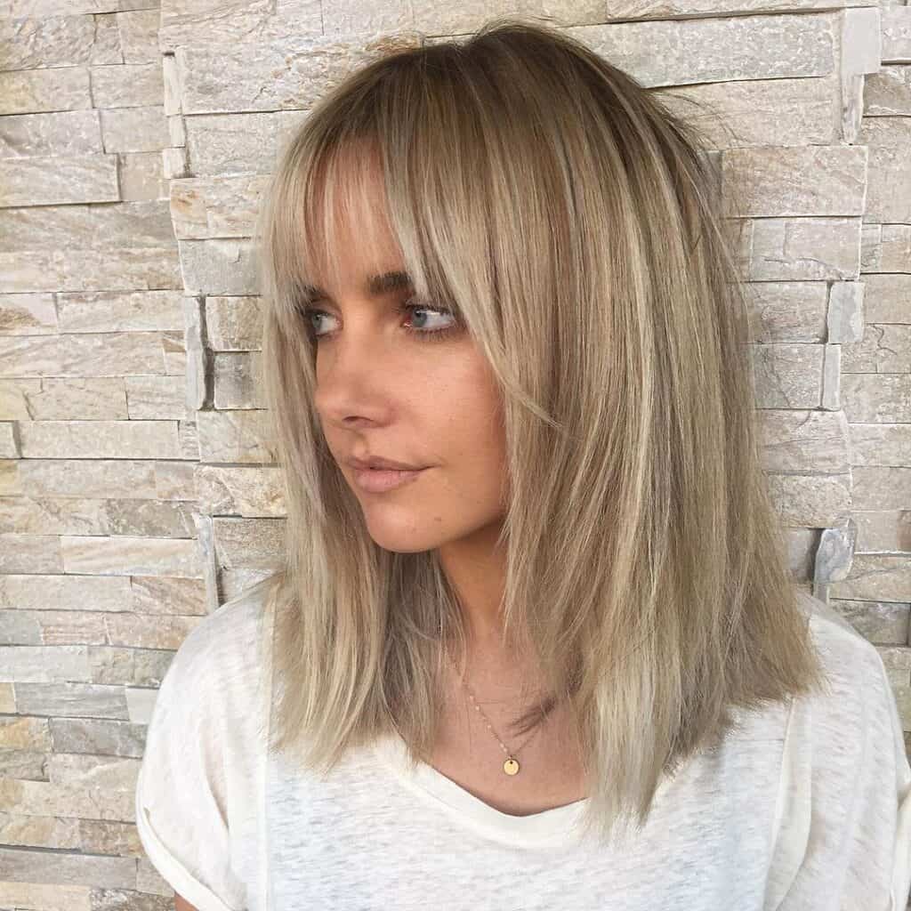 feathered medium hairstyle with bangs on thin hair